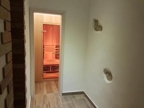 a hallway with a door leading to a kitchen at Apartments Fazarinc with parking, wellness and city store in the center of Celje in Celje