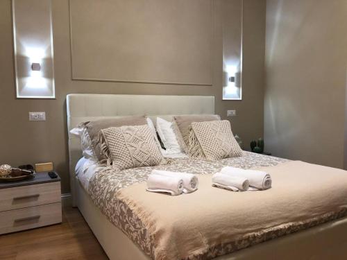 a bedroom with a bed with two towels on it at Pantheon Luxury Suite in Rome