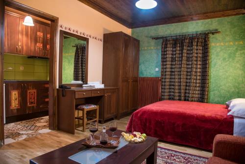 a hotel room with a bed and a desk at Hotel Kroupi in Elati Trikalon