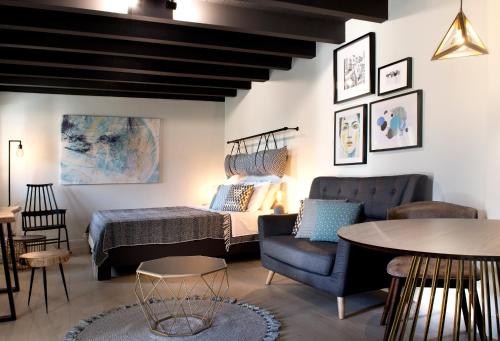 a living room with a bed and a table and chairs at Rocks Republic in Kalabaka
