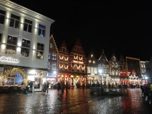 a group of buildings on a street at night at Kuai Guestroom Brugge in Bruges