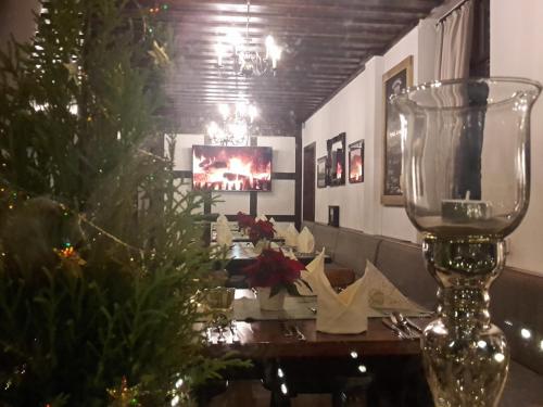 a dining room with a christmas tree and a table at Hotel Bigger Hof - Wirtshaus Platzhirsch am Jahnplatz in Olsberg