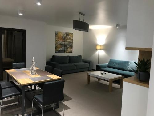 a living room with a couch and a table at Villa Gor in Bukovel