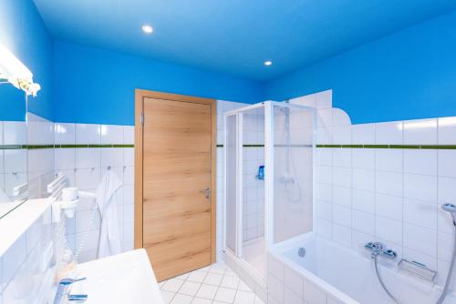 a bathroom with a shower and a tub and a toilet at Ibex Lodge in Sankt Anton am Arlberg