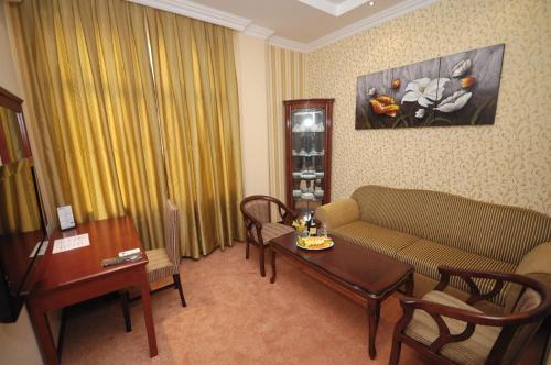 a living room with a couch and a table at Royal Hotel in Baku