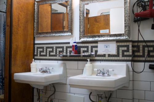 a bathroom with two sinks and two mirrors at Interfaith Retreats in New York