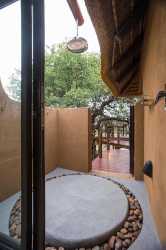 an outside view of a room with a round rug and a window at Naledi Lodges in Balule Game Reserve