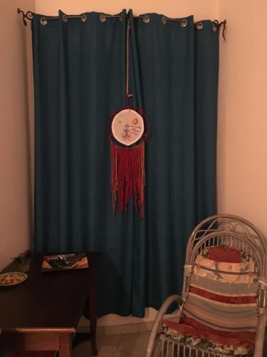a blue curtain with a clock hanging in a room at Pedrales Orgosolo in Orgosolo