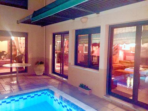 a swimming pool in the middle of a house at 4-seasons pool villa near Meteora in Tríkala