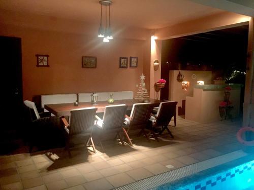 a kitchen and dining room with a table and chairs at 4-seasons pool villa near Meteora in Tríkala