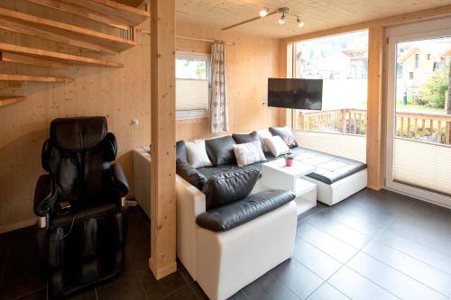 a living room with a white couch and a chair at Aron Chalet Kreischberg 10A in Sankt Lorenzen ob Murau