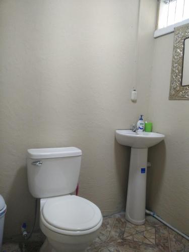 a bathroom with a toilet and a sink at Casa Chayito in Santa María
