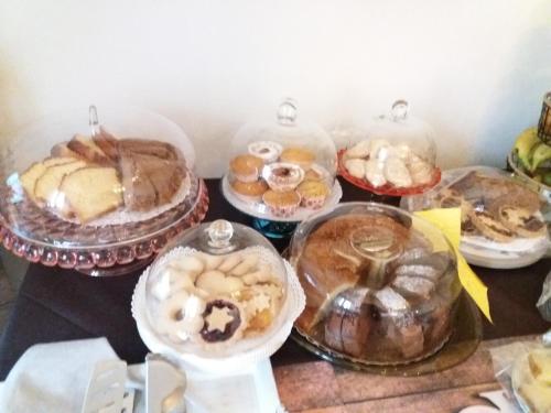 a bunch of different types of pastries on a table at Locanda 130 in Fonni