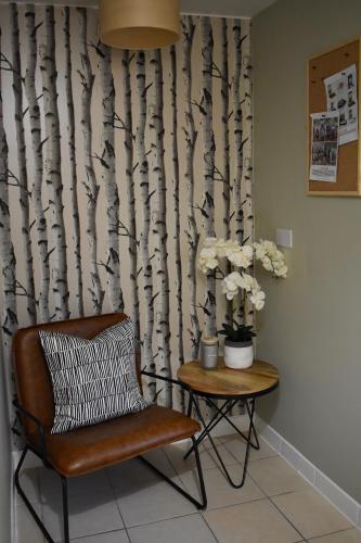 a chair and a table with a tree mural at The Spinney in Bracknell