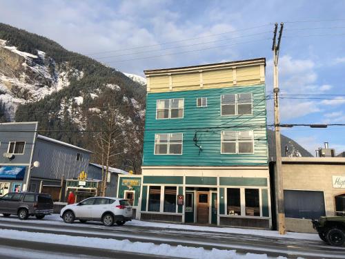 a blue building on the side of a street at Historic Hotel Bayview in Stewart