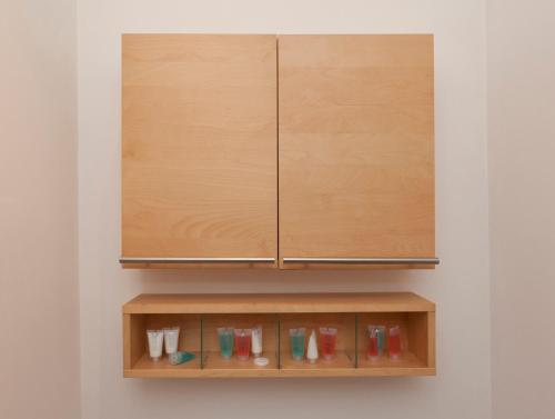 a wooden cabinet hanging on a wall at Lace Market Apartments - City Centre - 4 Beds Apartment with 2 Bathrooms and full Kitchen in George Street - close to Victoria Centre Shopping Centre - Parking for Cars & Vans from Five Pounds a Day - Sunday 1pm Check-out in Nottingham