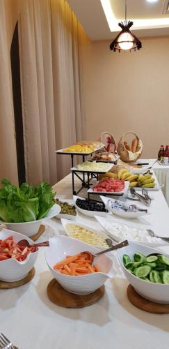 a table with many bowls of food on it at Muscat Plaza Hotel in Muscat