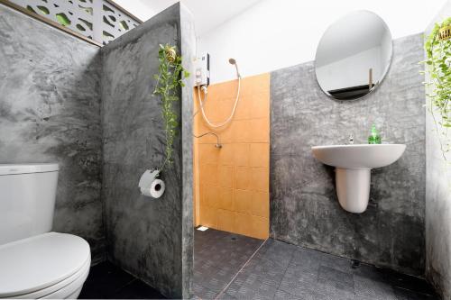 ein Badezimmer mit einem weißen WC und einem Waschbecken in der Unterkunft Green Pepper in Ko Lanta