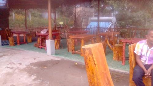 a man sitting in front of a group of tables at Green View Ella in Ella