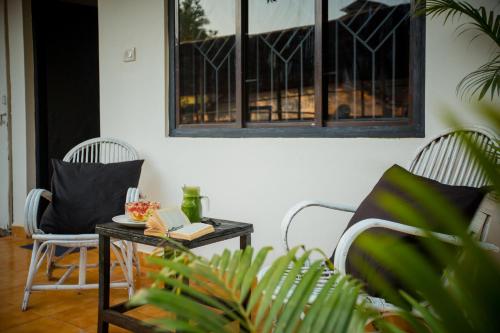 a living room with two chairs and a table at Crystall Goa, Onyx Edition in Palolem