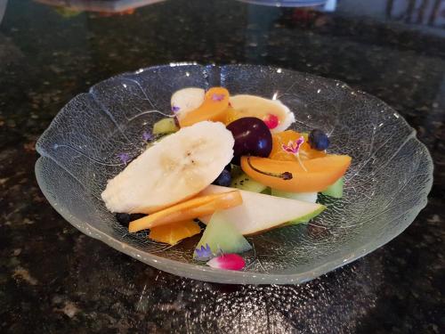 a plate of fruit and vegetables on a table at Villa Te Soro Bed and breakfast in Auckland