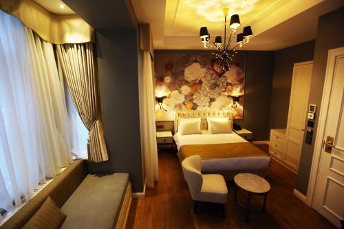 a hotel room with two beds and a couch at Royal Tophane in Istanbul