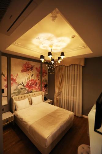 a bedroom with a large bed with a ceiling at Royal Tophane in Istanbul