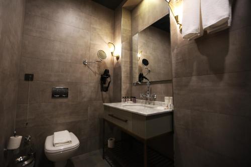 a bathroom with a sink and a toilet at Royal Tophane in Istanbul