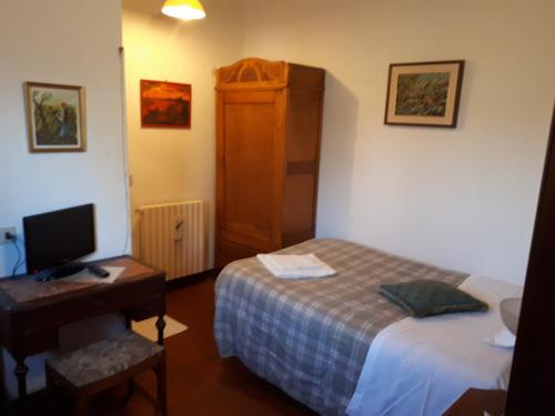 a bedroom with a bed and a desk with a computer at Biogarden in Zelarino
