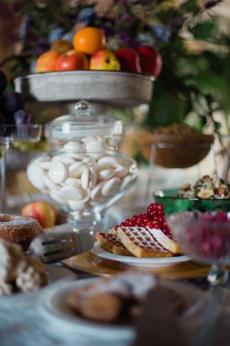 a table topped with plates of food and fruit at I giardini segreti di Villa Marcello Marinelli in Cison di Valmarino