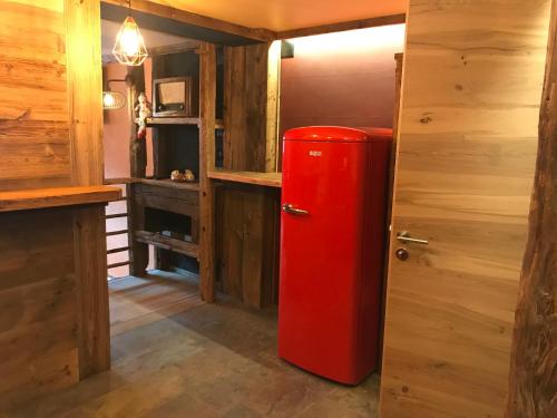 an old red refrigerator in a room with wooden walls at Chalet Schuler in Zermatt