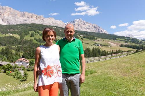 a man and a woman standing on top of a mountain at Antorè in Badia