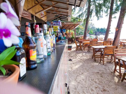 a bar with bottles of alcohol sitting on top of it at Baan Tubkaek Hotel in Tab Kaek Beach