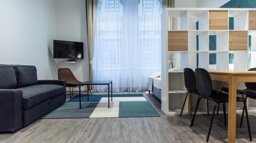 a living room with a couch and a table at BpR Downtown Gemstone Apartments in Budapest