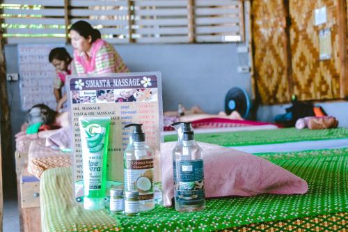 two bottles of water on a table with two beds at Baan Tubkaek Hotel in Tab Kaek Beach