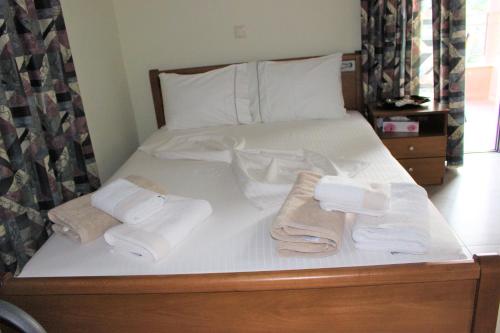 a bed with towels and pillows on it at Villa Rena in Sivota