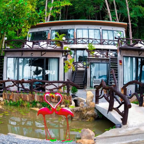 a house with a lot of water in front of it at Baan Tubkaek Hotel in Tab Kaek Beach