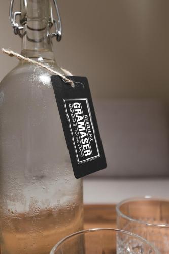 a bottle with a label on it sitting on a table with glasses at Residenz Gramaser GmbH in Ischgl