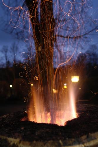 a fire pit with a building in the background at Malerhaus am Kolbergarten in Bad Tölz