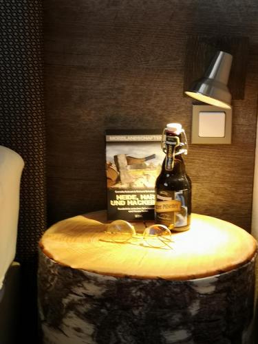 a bottle of whiskey sitting on top of a table at Hotel am Kurpark in Bad Lauterberg