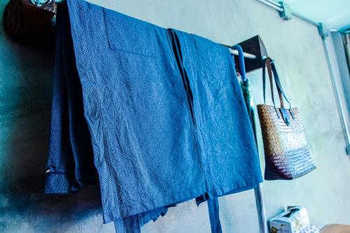 a blue shirt hanging on a clothes line at Baan Tubkaek Hotel in Tab Kaek Beach