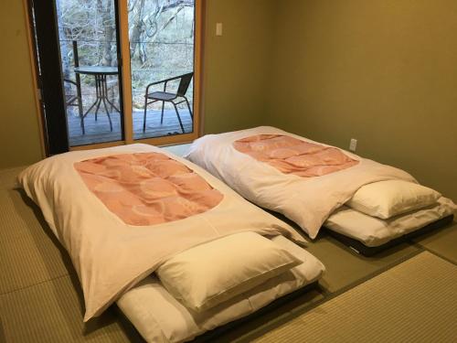 Postel nebo postele na pokoji v ubytování B&B Izumi Nikko