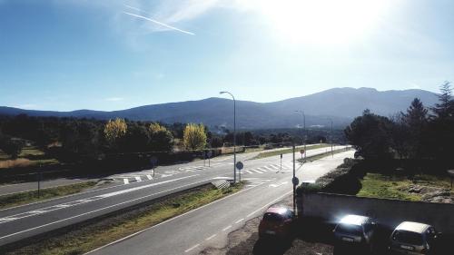 a truck driving down a highway with mountains in the background at Hospedaje Casa Mariano in Segovia
