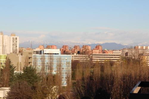 a city skyline with buildings and mountains in the background at Sofia Sweet Home - Corsico in Corsico