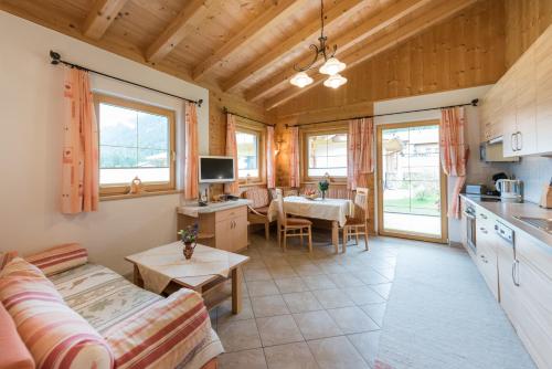 a living room with a couch and a table at Almdorf Tirol in Haldensee