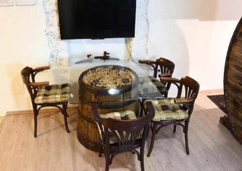 a dining room with a table with chairs and a tv at Apartments FABRKA in Ljubljana