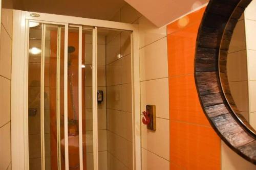 a bathroom with a shower and a mirror at Apartments FABRKA in Ljubljana