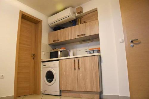 a kitchen with a washer and dryer in a room at Apartments FABRKA in Ljubljana