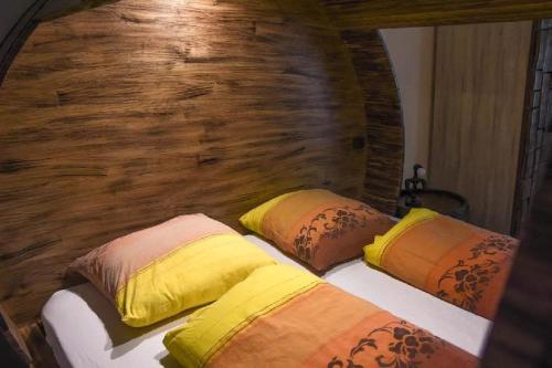 two pillows on a bed in a room with a wall at Apartments FABRKA in Ljubljana