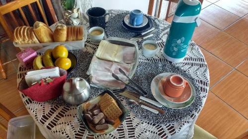 a table with a table cloth with food on it at Pousada Taiani in Itaara